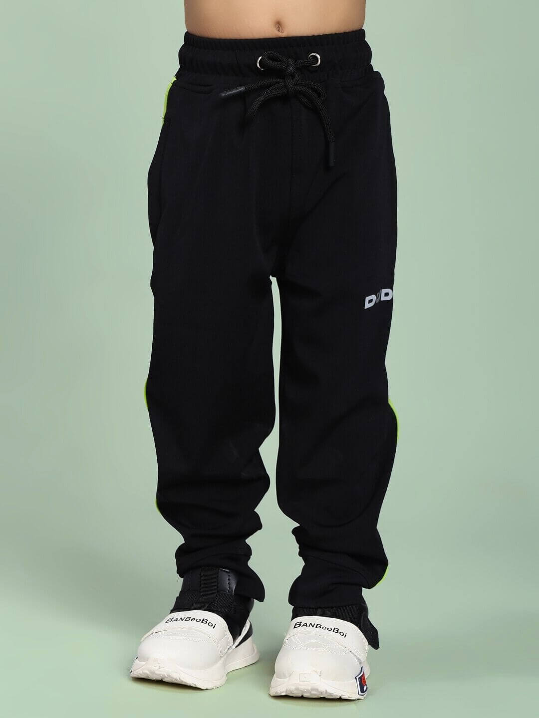 Child wearing HIGH PERFORMANCE JOGGER FOR BOYS AND GIRLS BLACK showing comfortable fit and stylish design.