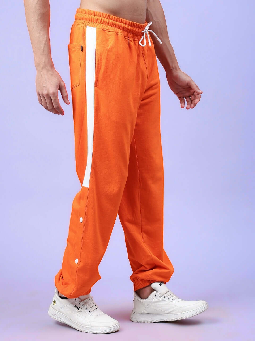 Man wearing High Point Contrast Joggers in orange and white with a custom fit option, made by DUDS tailors.