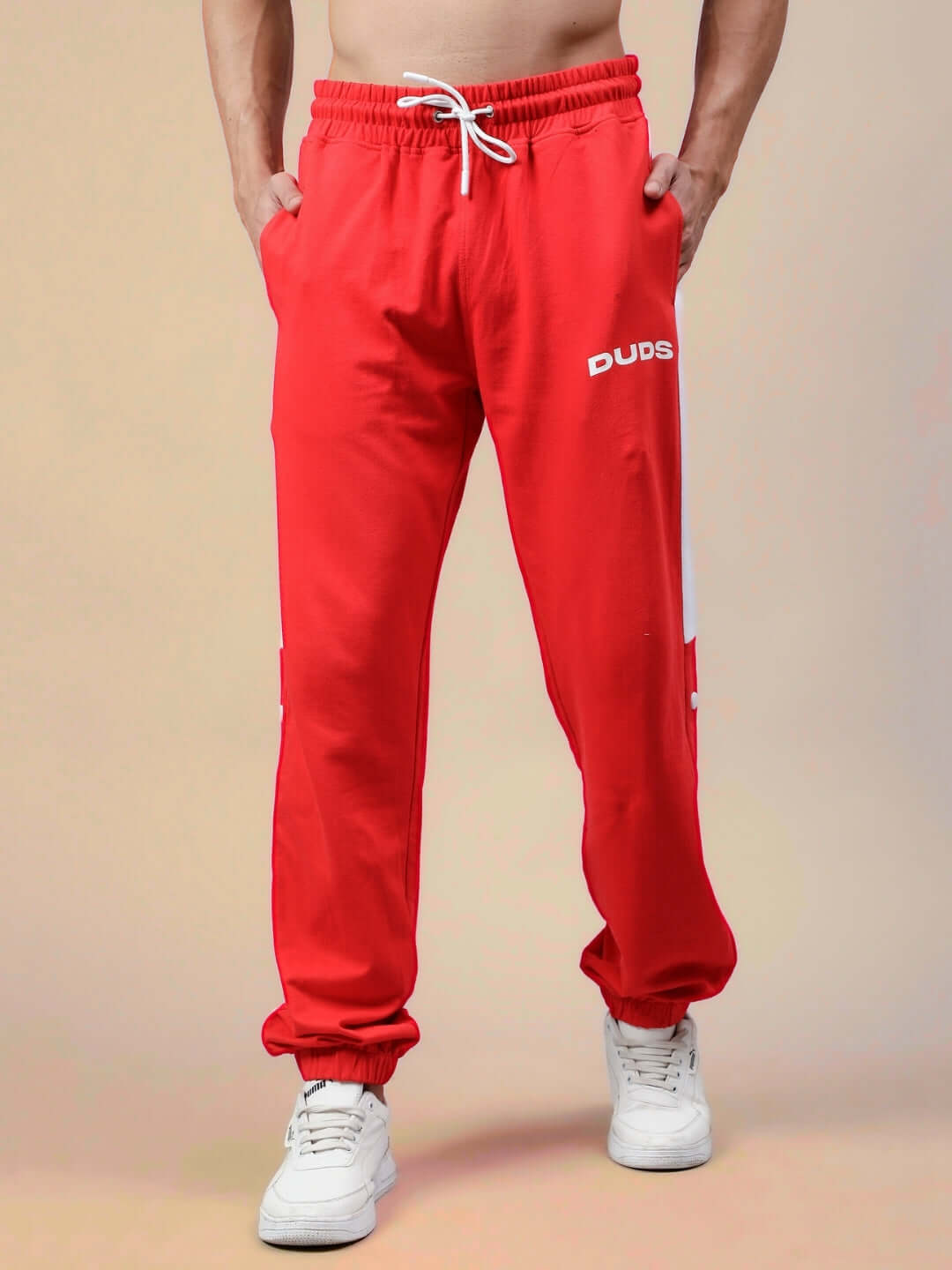 Model wearing red-white High Point Contrast Joggers by DUDS, showcasing drawstring waist and side pockets.