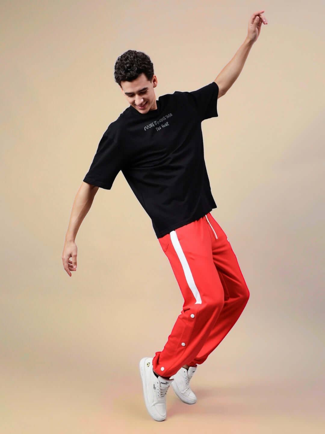 Person wearing High Point Contrast Joggers in red and white, dynamically posing against a neutral background. Fashionable and custom-fit options.