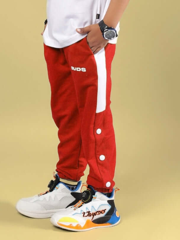 Child wearing HIGH POINT JOGGER FOR BOYS & GIRLS RED with stylish sneakers, showcasing comfortable and trendy fashion for kids.