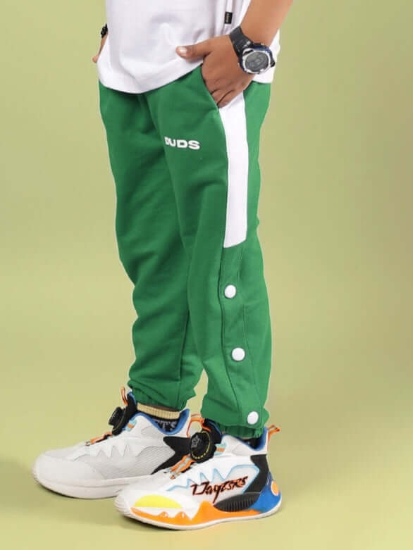HIGH POINT JOGGER FOR BOYS & GIRLS GREEN, featuring comfortable athletic design, shown with stylish shoes.