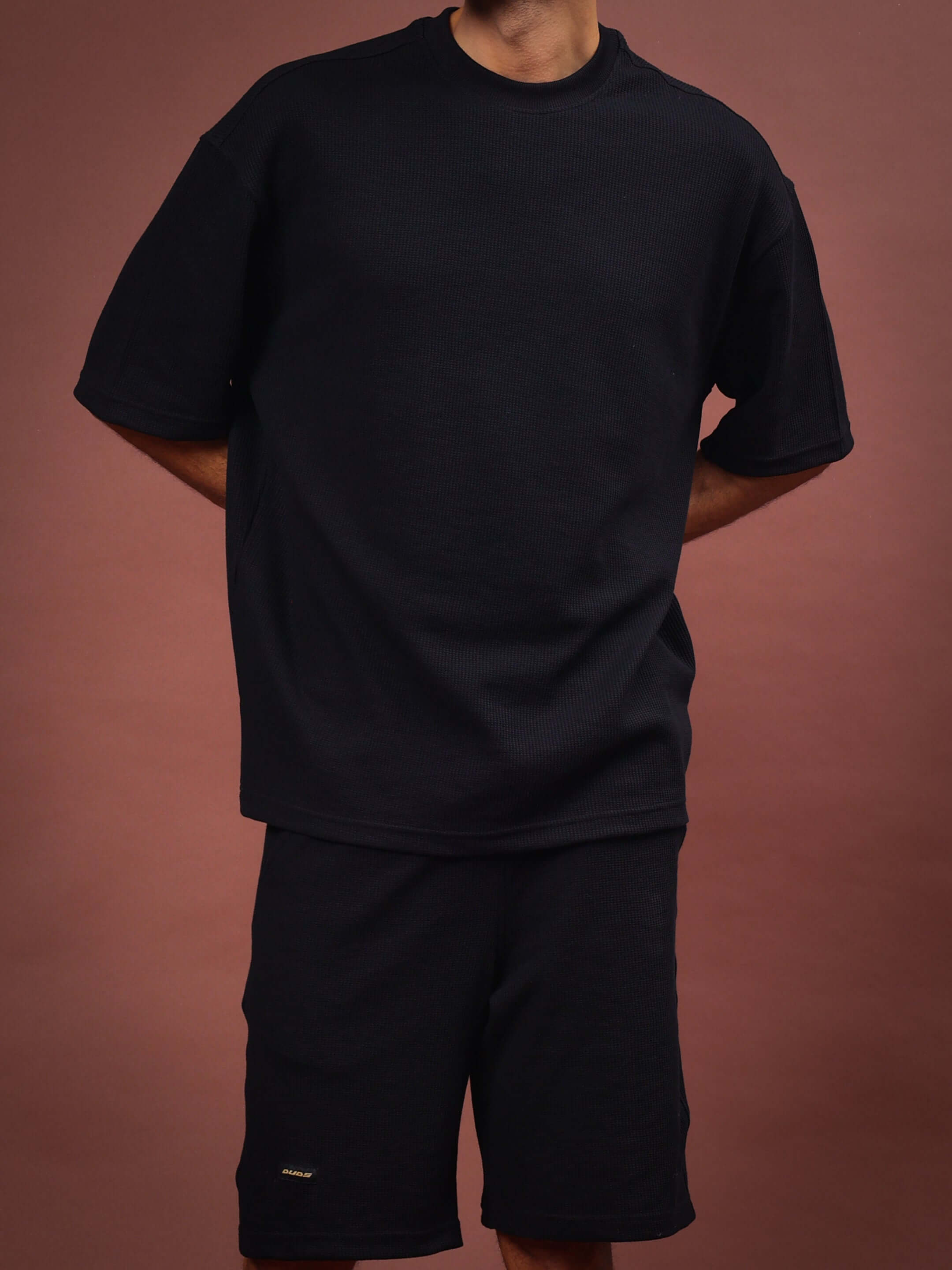 Model wearing HIGHKEY Solid Black Co-Ord Set, showcasing relaxed fit. Custom Fit option available for personalized sizing. Handmade quality.