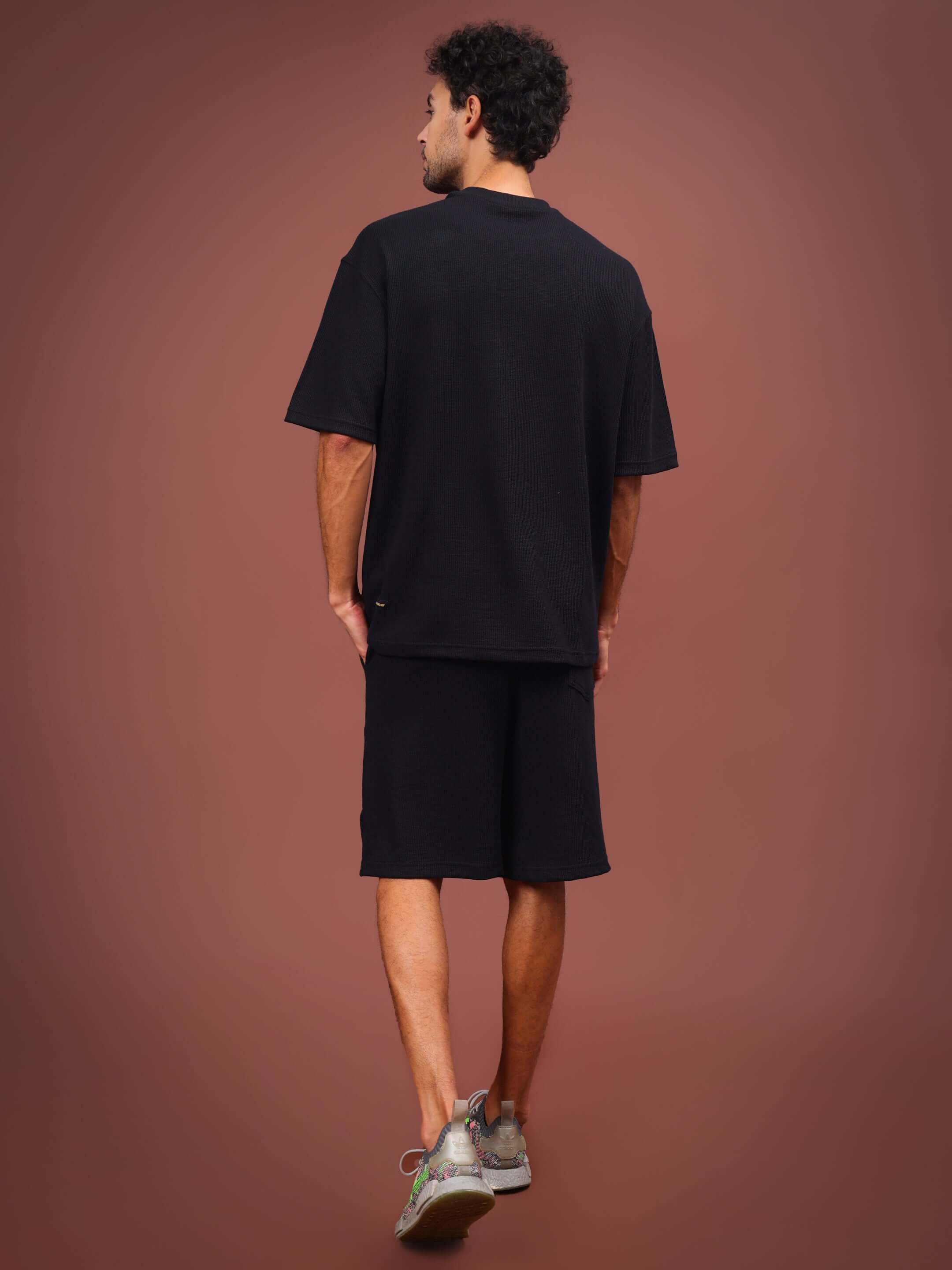 HighKey solid black co-ord set showcasing back view on model, perfect for stylish casual wear, available in custom fit sizes.