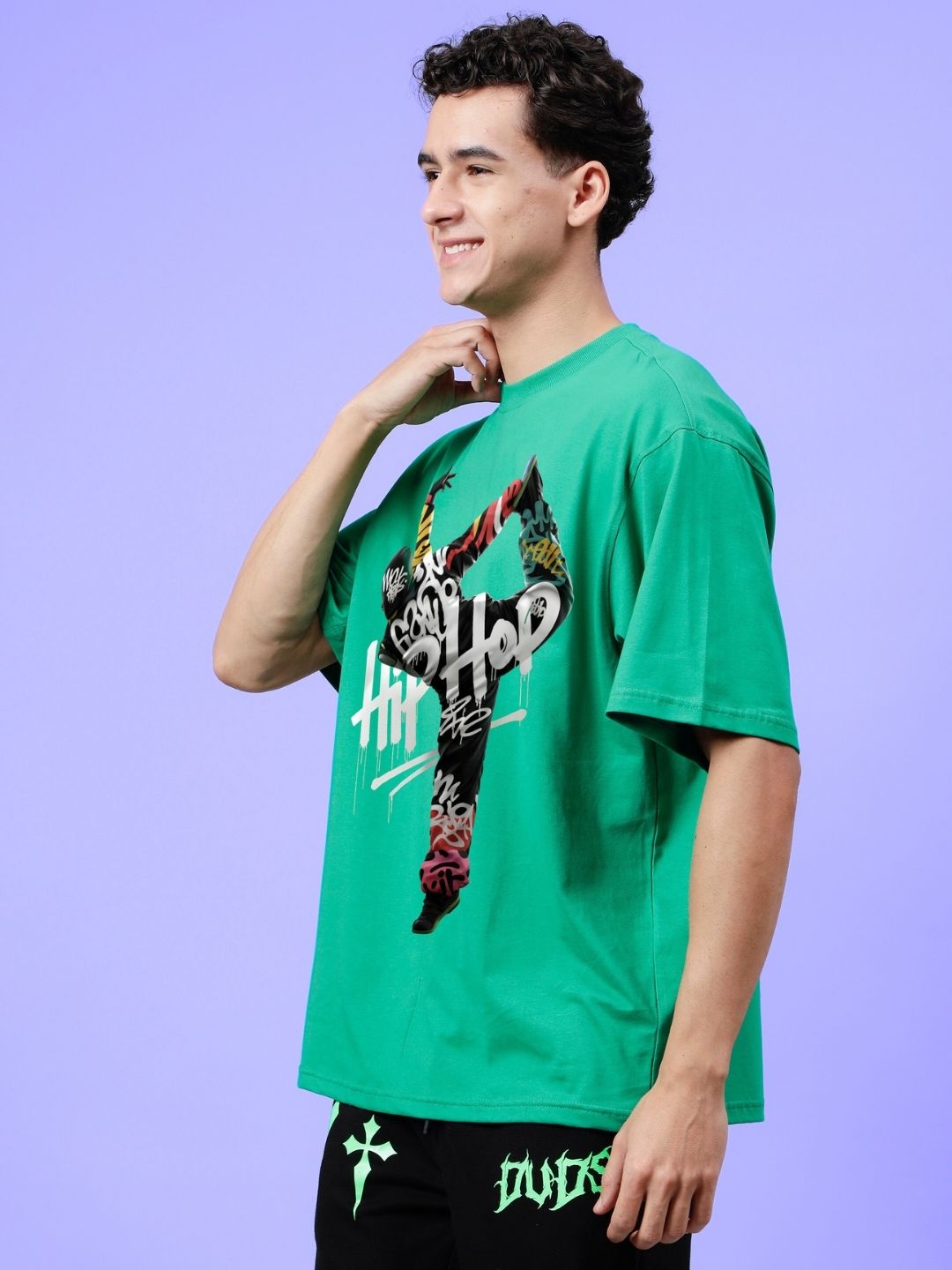 Model wearing HIP HOP OVER-SIZED T-SHIRT GREEN with streetwear style on a lavender background