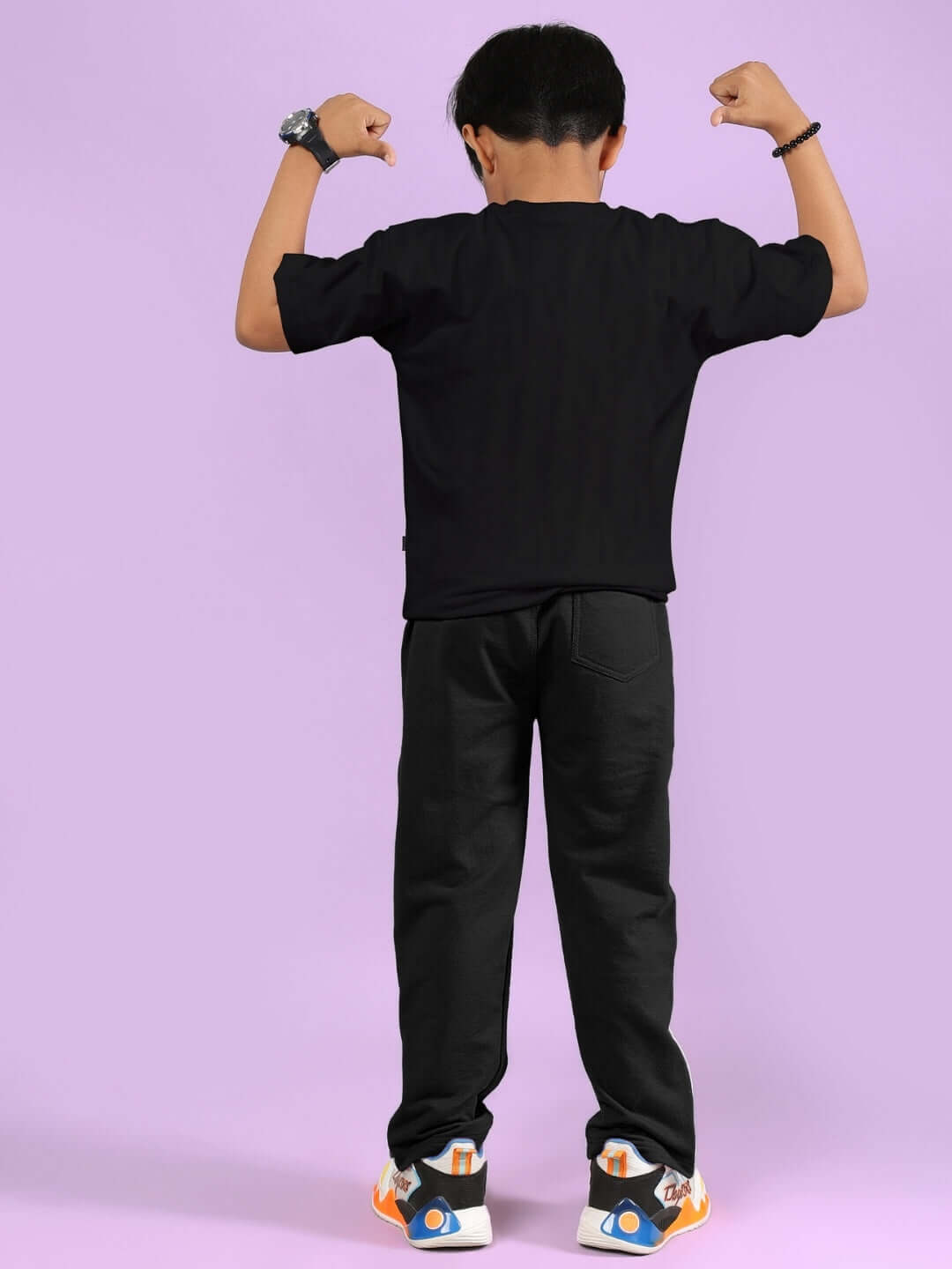 Child wearing HIP HOP TEDDY CO-ORD FOR BOYS & GIRLS BLACK, showing back, on purple background.