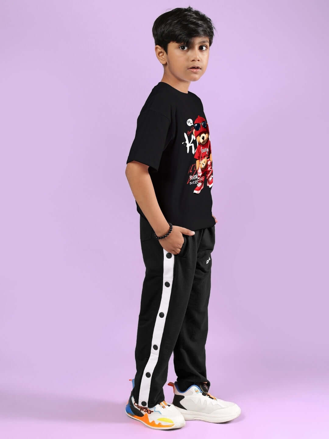 Young boy wearing HIP HOP TEDDY CO-ORD FOR BOYS & GIRLS BLACK enjoying stylish casual outfit.