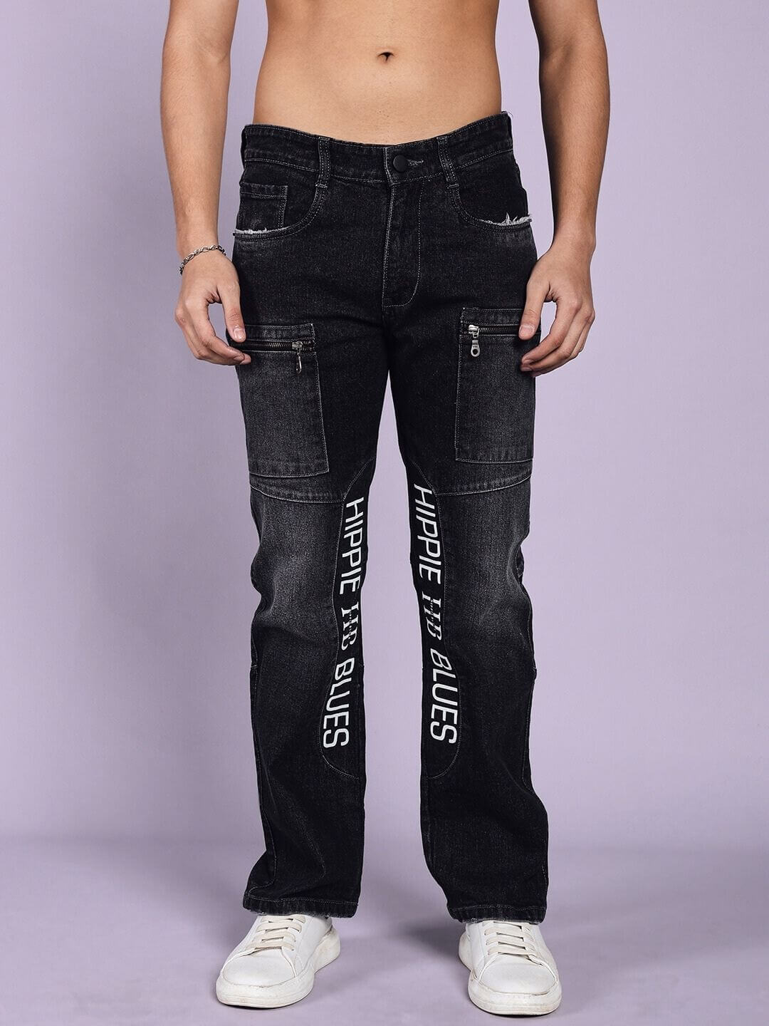 Model wearing Hippie Black Regular Fit Denim Jeans by DUDS, showcasing unique design and text, suitable for custom fit orders.