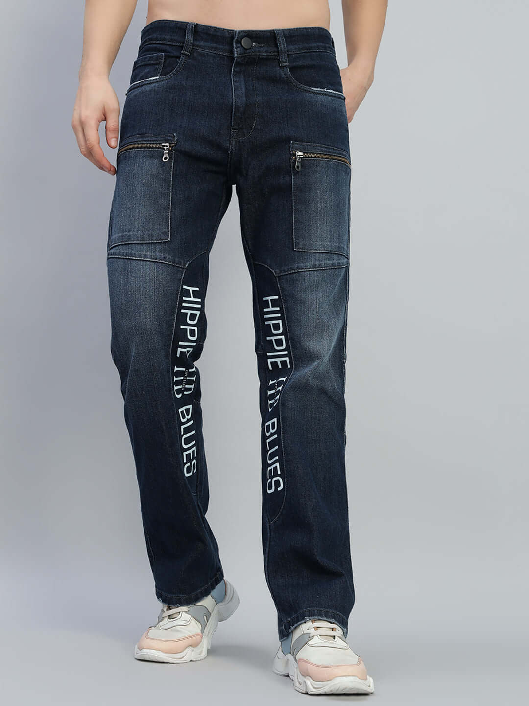 Model wearing HIPPIE BLUE regular fit denim jeans with front pockets and text details, showcasing comfortable and stylish design.