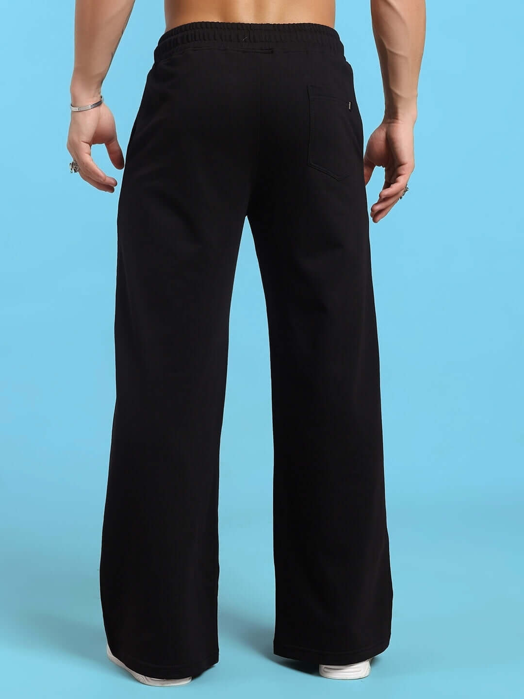 Back view of HOLLISTER COTTON JOGGERS BLACK on person against blue background.