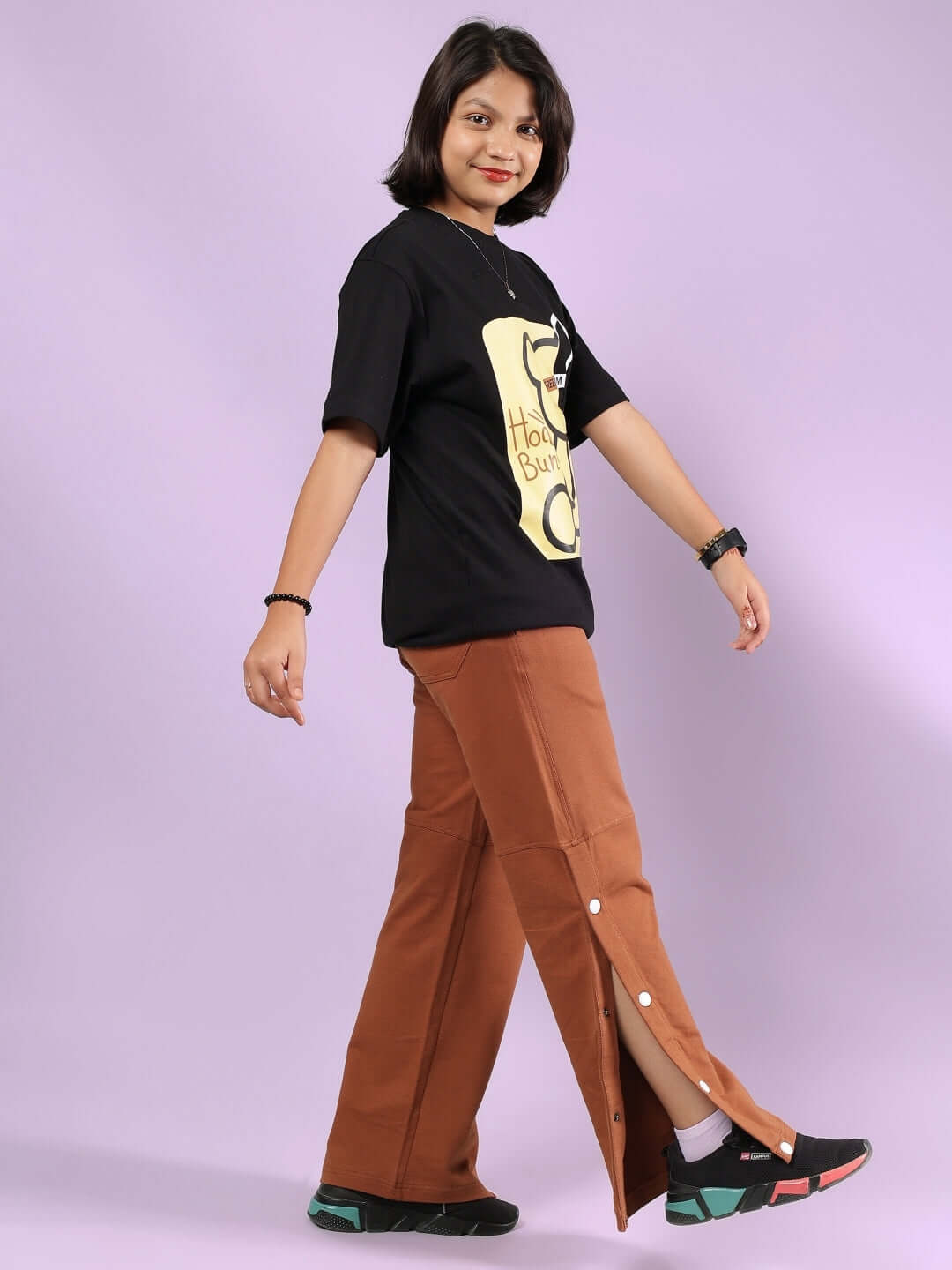Child wearing HONEY BUNNY CO-ORD FOR BOYS & GIRLS BLACK-BROWN outfit featuring a black top and brown pants.