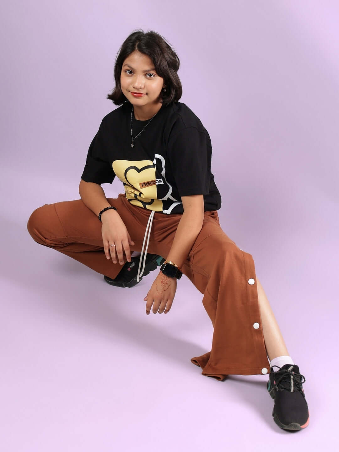 HONEY BUNNY CO-ORD FOR BOYS & GIRLS BLACK-BROWN, a stylish unisex outfit, modeled by a person in brown pants and black top.
