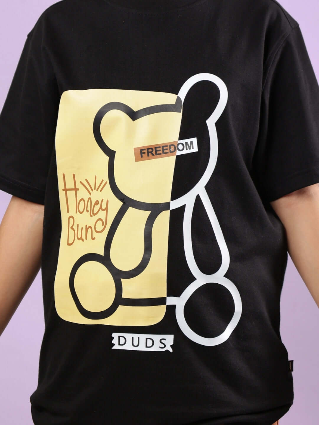 Child wearing DUDS HONEY BUNNY CO-ORD FOR BOYS & GIRLS BLACK-BROWN with bear graphic and text FREEDOM.