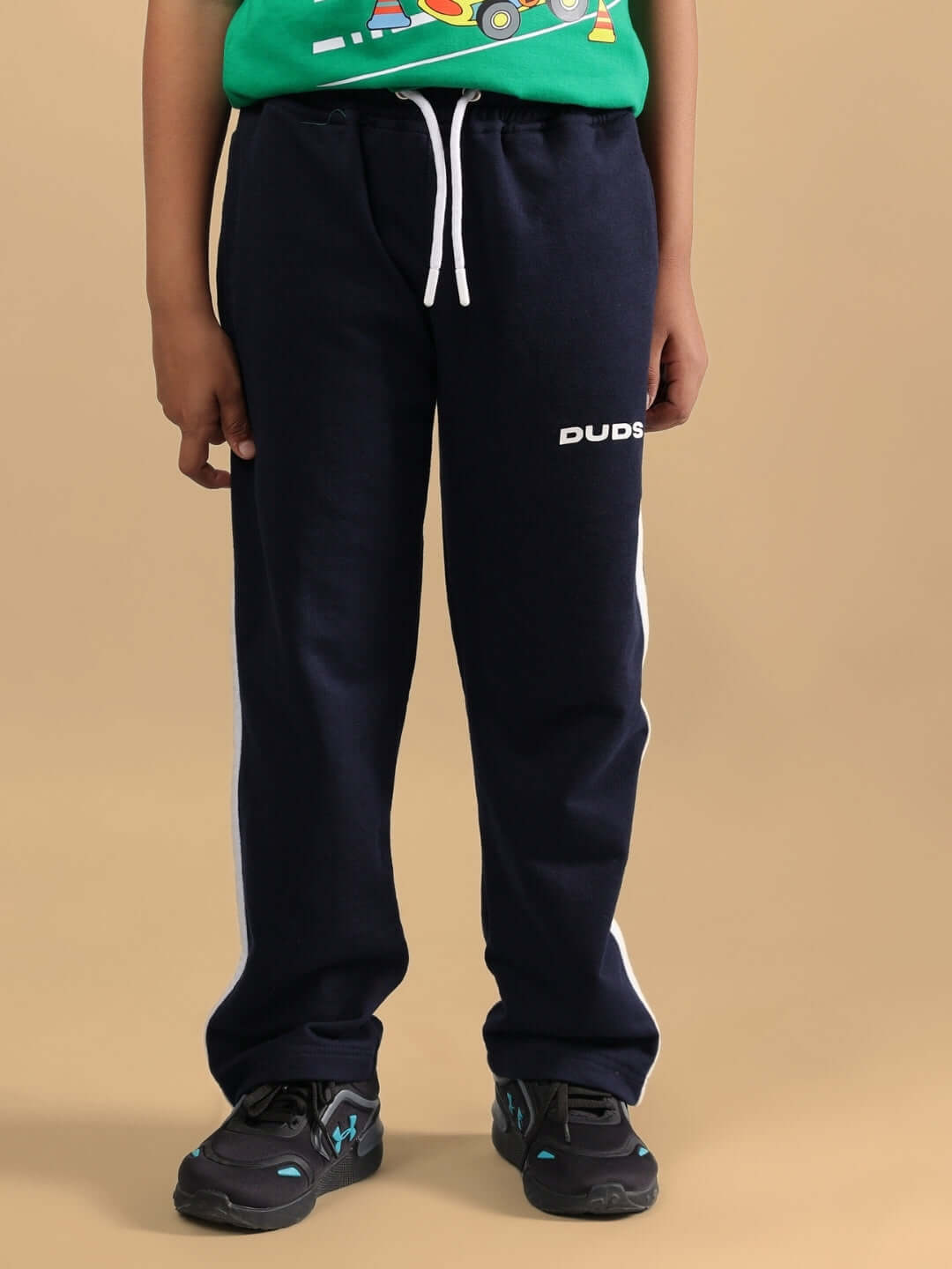 Child wearing HOOFER JOGGER FOR BOYS & GIRLS NAVY BLUE-GREEN with white drawstring and DUDS logo.