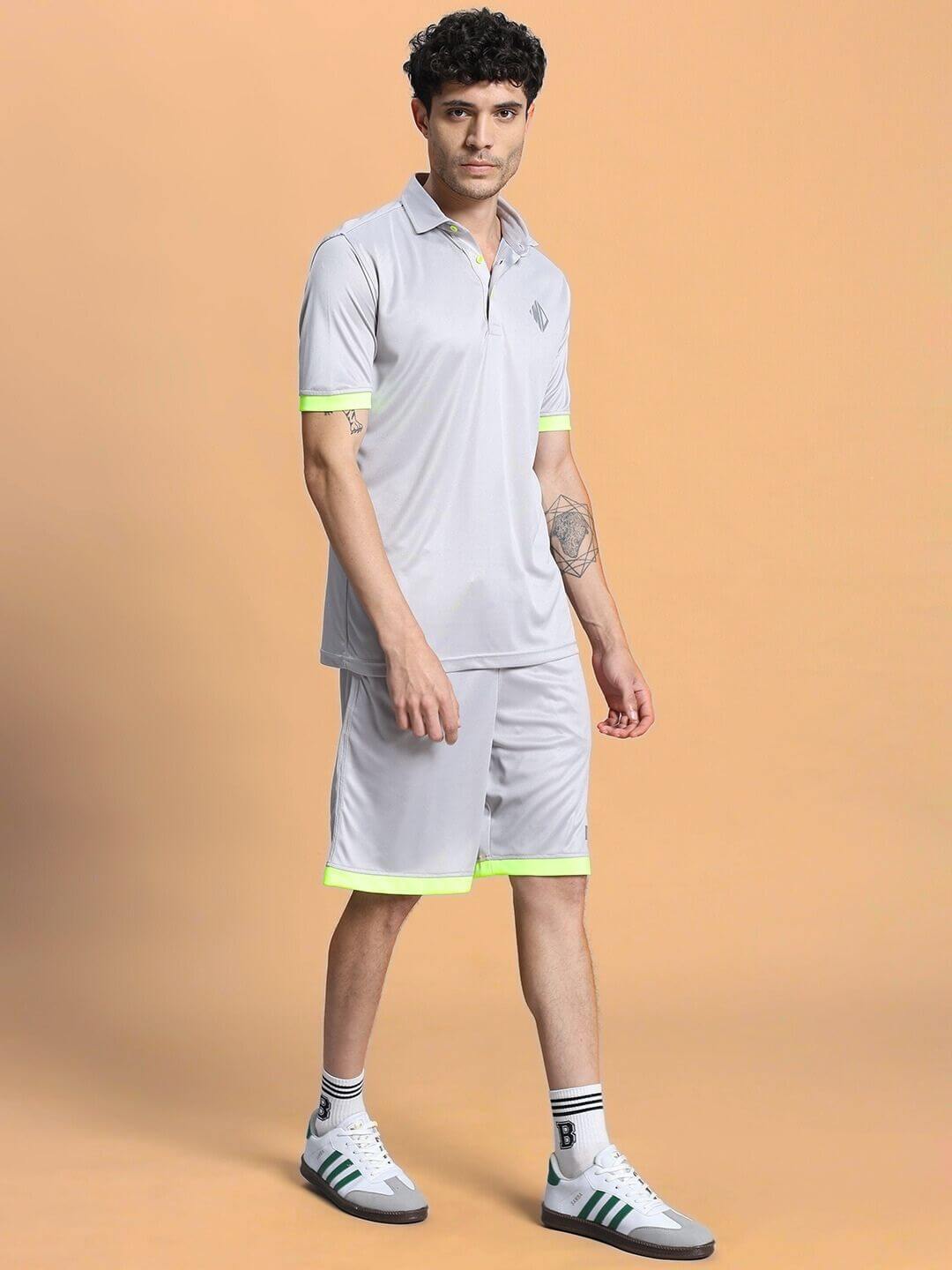 Man wearing HOOKUP SUMMER POLYESTER CO-ORD SET GREY with neon accents in a casual pose against a neutral background.