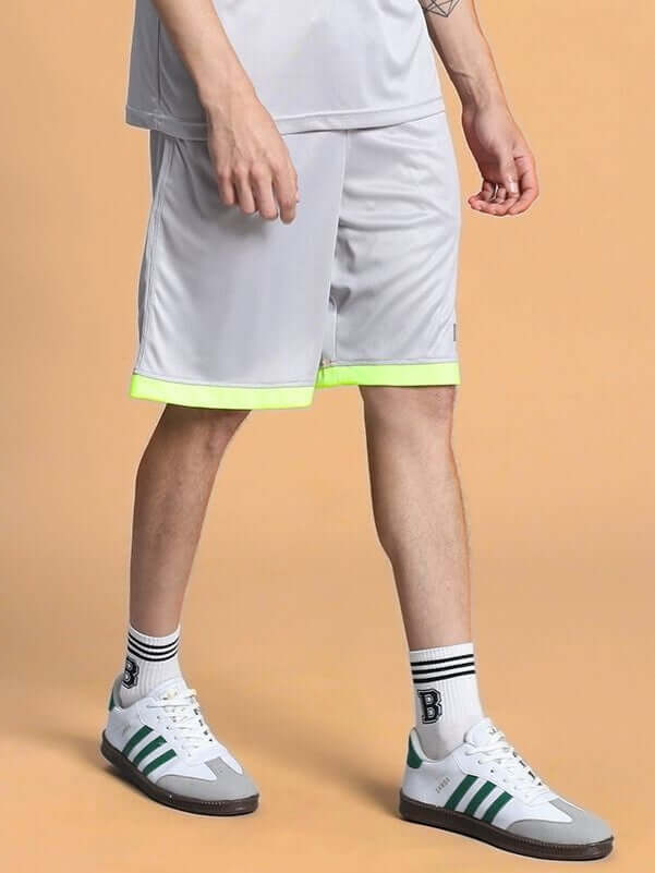 Man wearing HOOKUP REGULAR FIT SHORTS GREY, casual style with sneakers.