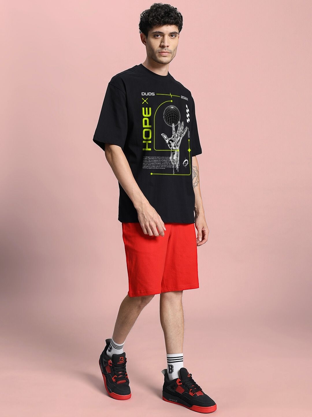 Model wearing HOPE PRINTED OVERSIZED CO-ORD SET BLACK RED with bold HOPE print, showcasing streetwear style.