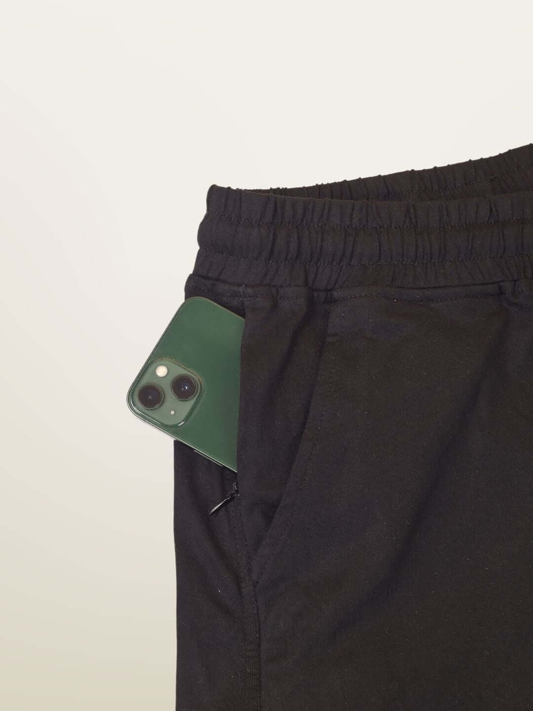 Black HOPE regular fit shorts with an iPhone in the pocket, customizable sizing options available for tailored fit.
