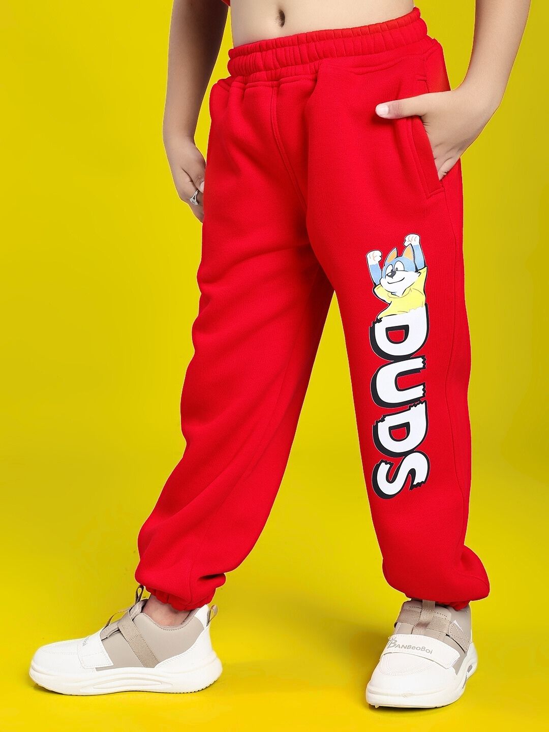 HUG WITH THE DOG FLEECE JOGGER FOR BOYS AND GIRLS RED, featuring fun dog design, ultra-soft fleece, and relaxed fit on yellow background