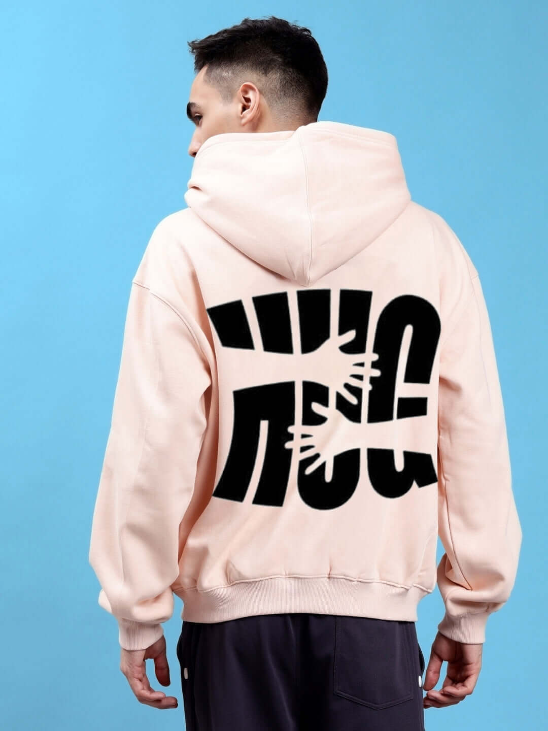 Model wearing HUG OVER-SIZED COTTON FLEECE HOODIES BEIGE showcasing back design on blue background