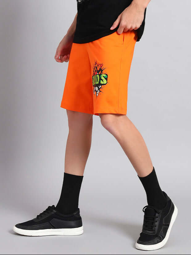 Person wearing Hulk Summer Shorts in bright orange color with graphic print, showcasing casual summer style.