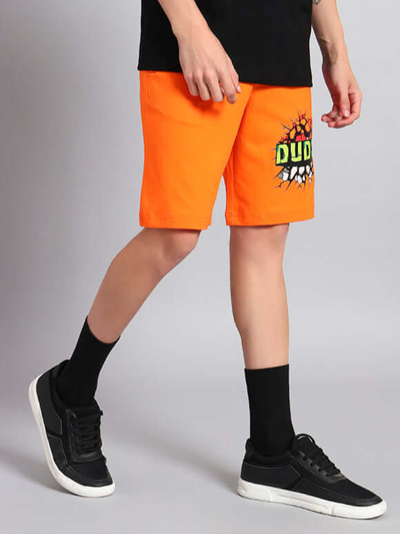 Model wearing orange HULK summer shorts from DUDS, featuring custom fit option and handmade quality for a perfect summer look.
