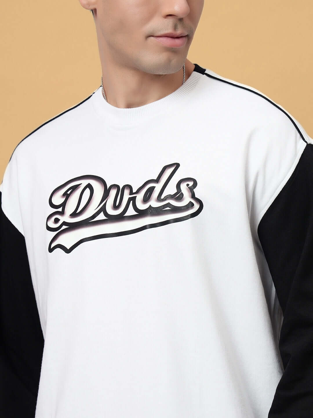 Model wearing HUNK oversized white sweatshirt with black sleeves, featuring Dvds logo. Made from premium cotton terry lycra blend.