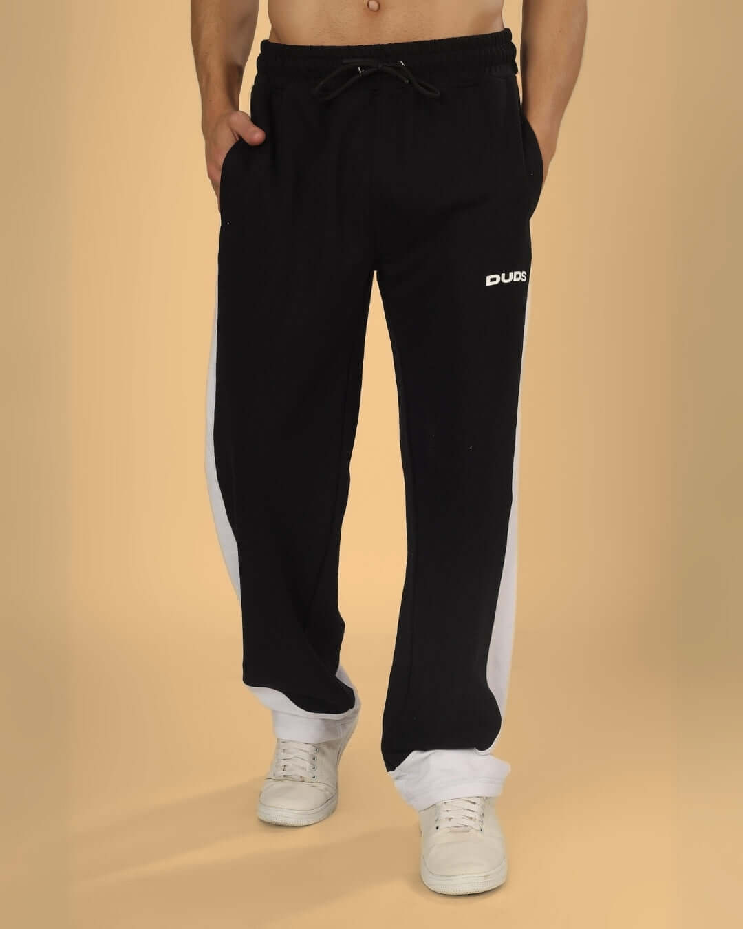 Man wearing black-white HURTLE Baggy Joggers from DUDS, featuring custom fit option and comfortable design for everyday wear.