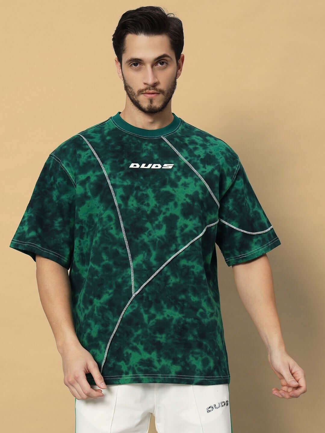 Green tie-dye oversized t-shirt made from premium cotton French terry, displayed on model. Features heavy gauge fabric and stylish design.