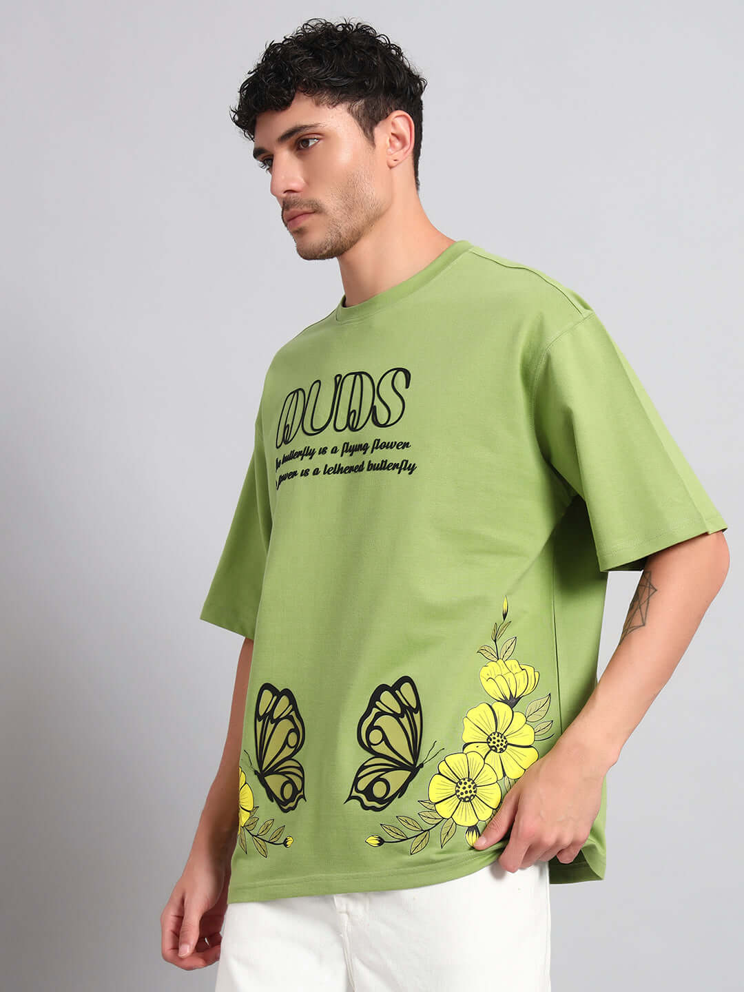 Man wearing IKON BUTTERFLY T-SHIRT GREEN MEN with butterfly graphic in vibrant green.