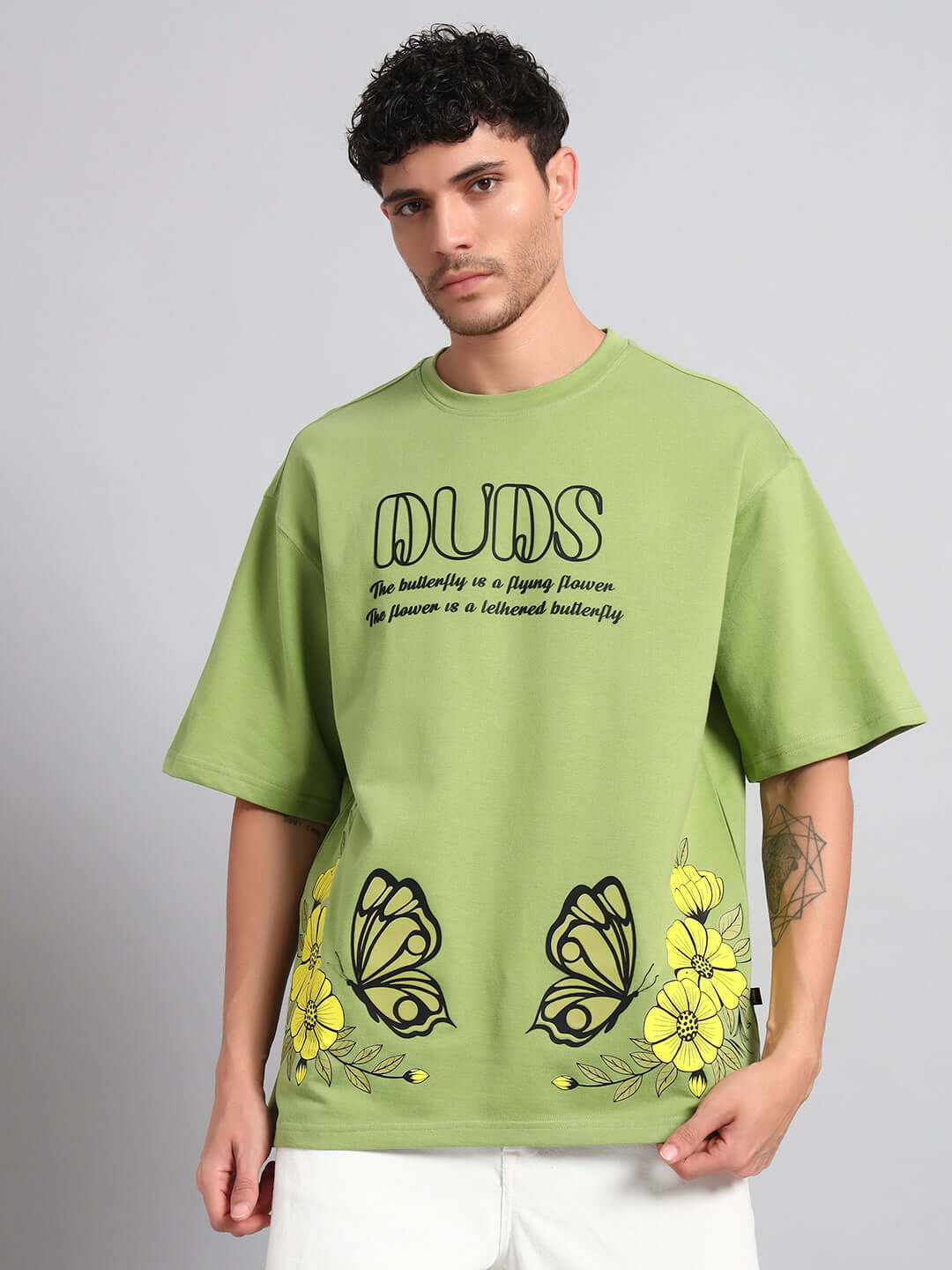 Model wearing IKON BUTTERFLY T-SHIRT GREEN MEN with bold butterfly graphic, stylish streetwear in vibrant green.