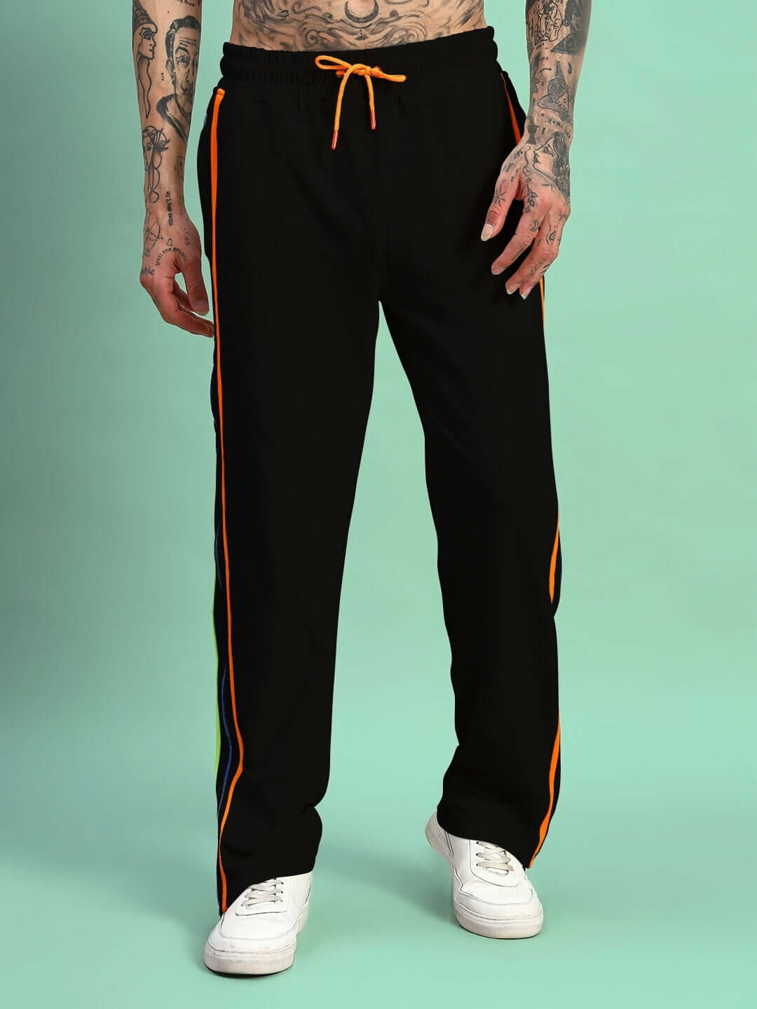 Model wearing Imperial Side Zipper Joggers in black with rainbow stripe detailing and white sneakers.