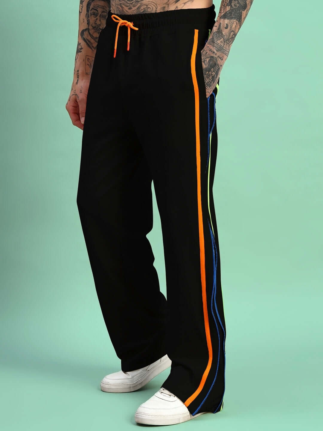 Model wearing Imperial Side Zipper Joggers in black with colorful stripes, showcasing casual style and comfort.