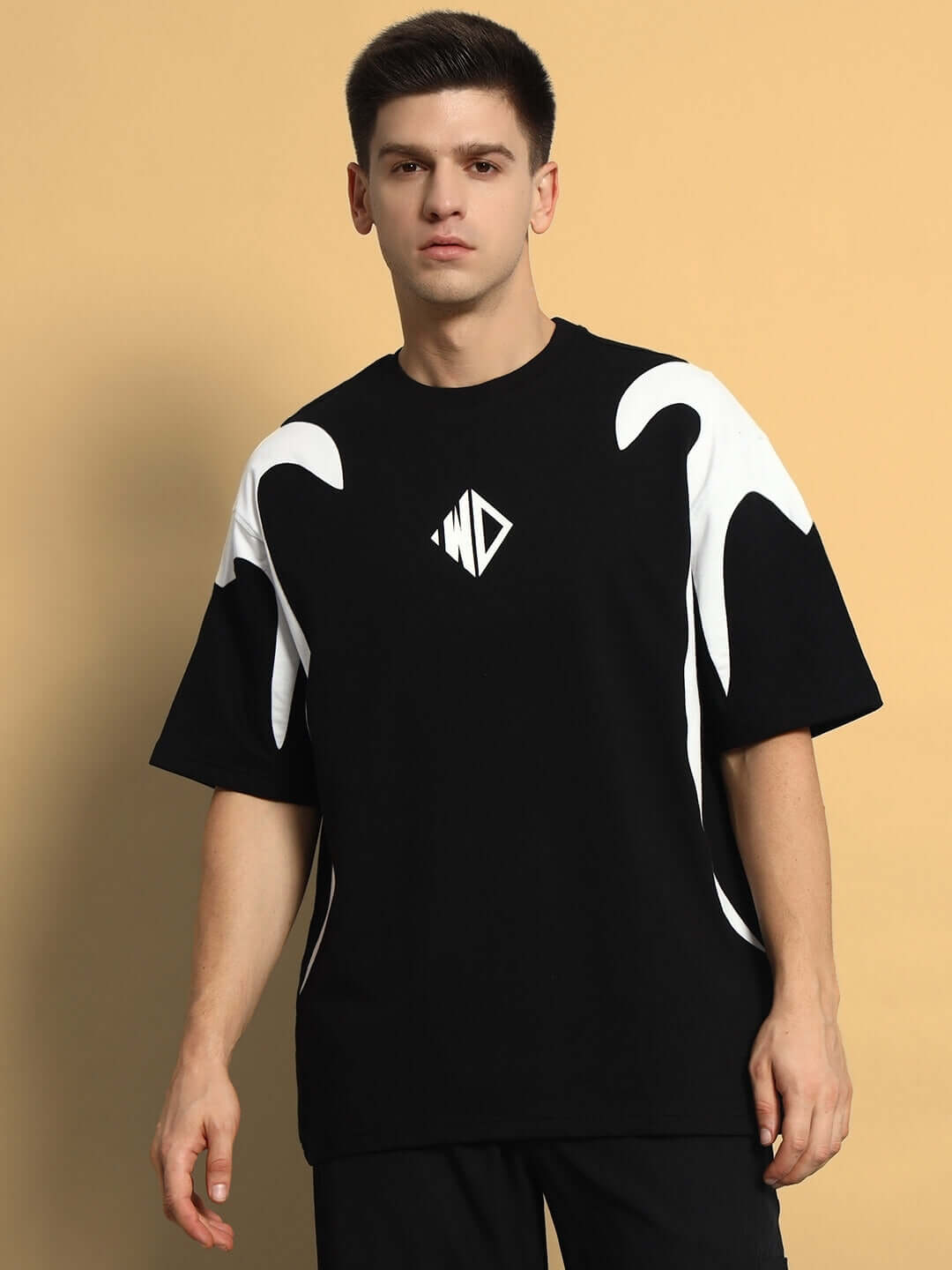 Model wearing Infinity Saga oversized black T-shirt with stylish white wave design, crafted from premium heavy gauge fabric for men.