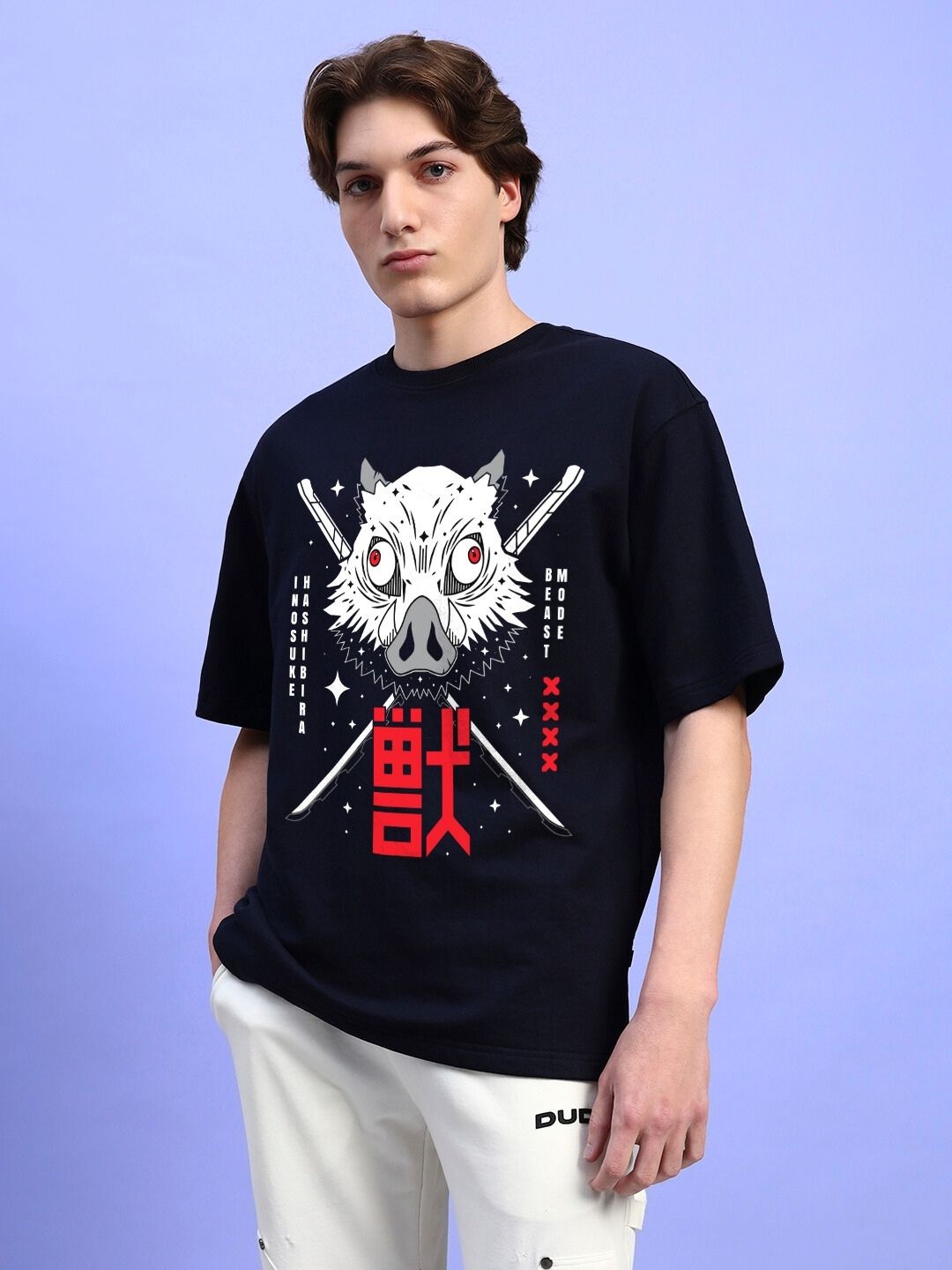 Man wearing INOSUKE PRINT OVERSIZED T-SHIRT BLACK with bold design, standing against a light blue background.