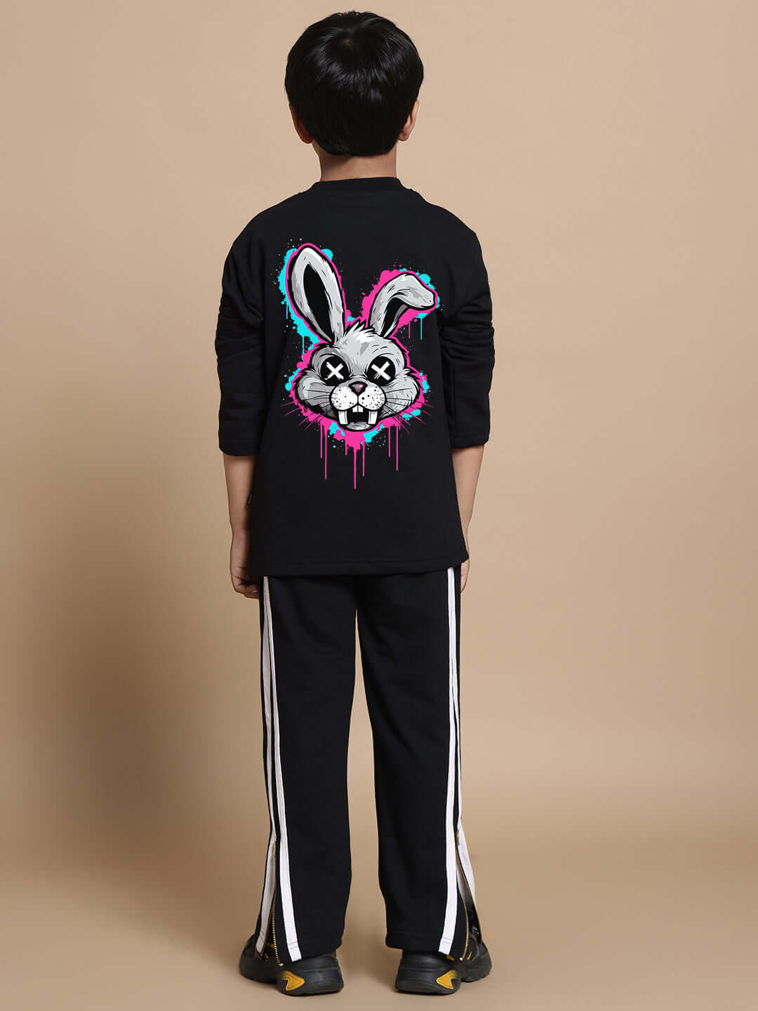 Child wearing black INSANE RABBIT CO-ORD set with colorful rabbit graphic, relaxed fit joggers, elastic waistband, premium cotton blend.