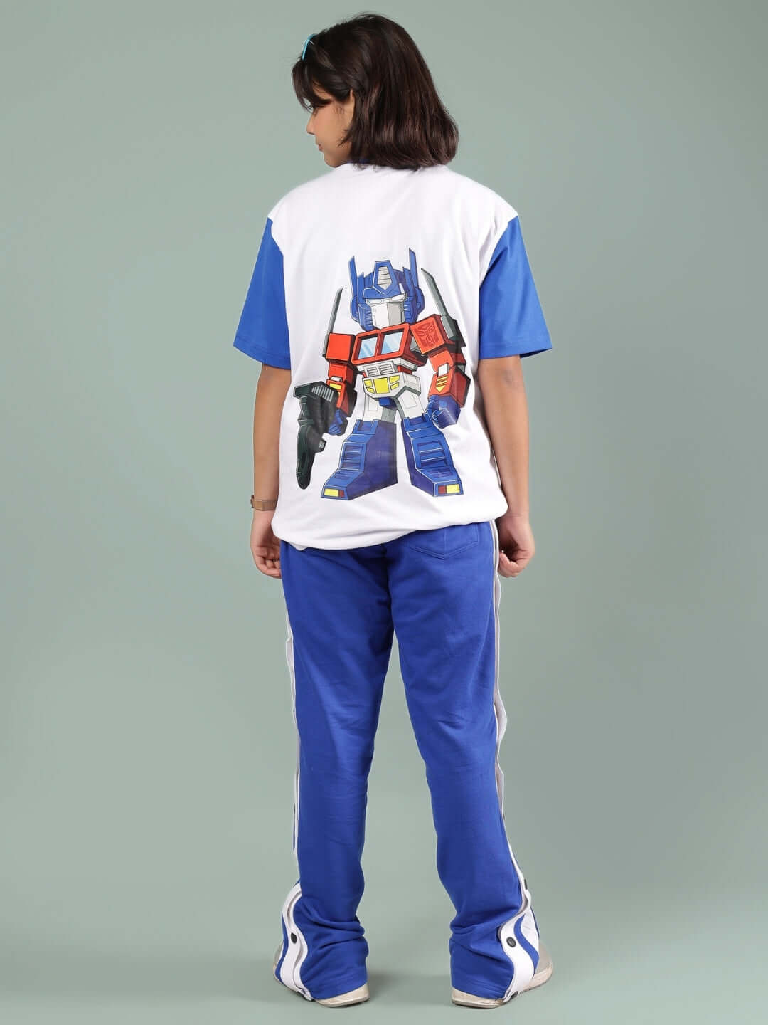 Child wearing IRONA CO-ORD FOR BOYS & GIRLS WHITE-R BLUE set with vibrant graphic on back.