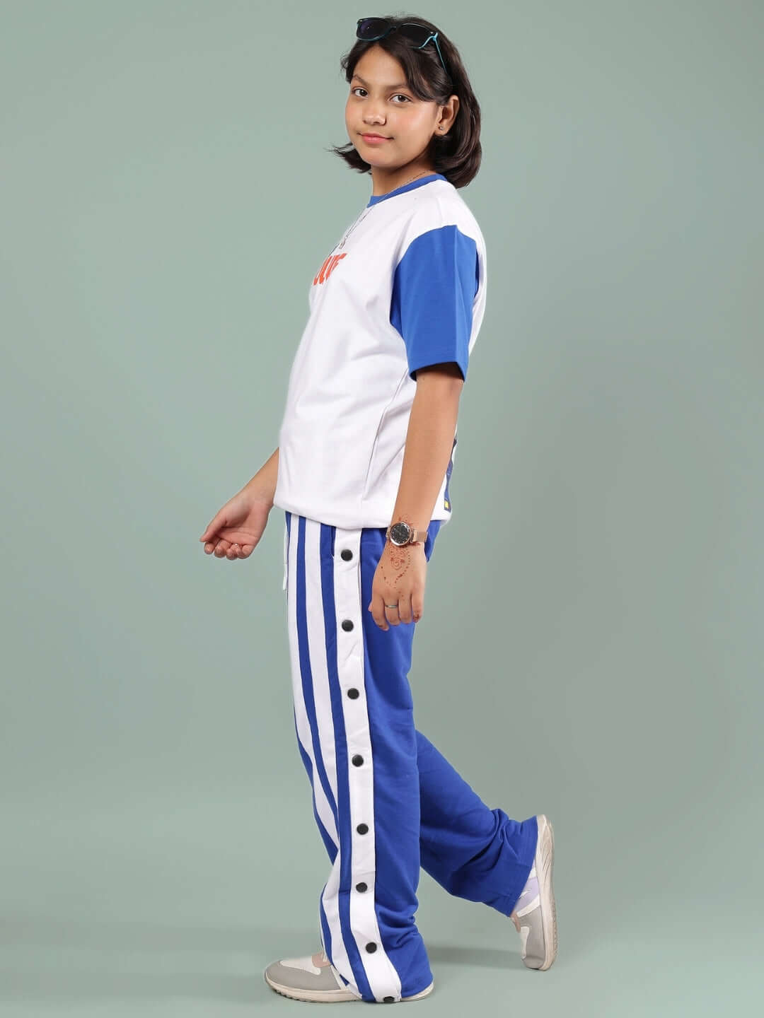Child wearing IRONA CO-ORD FOR BOYS & GIRLS WHITE-R BLUE, featuring a white top and blue pants with side stripes, casual look.