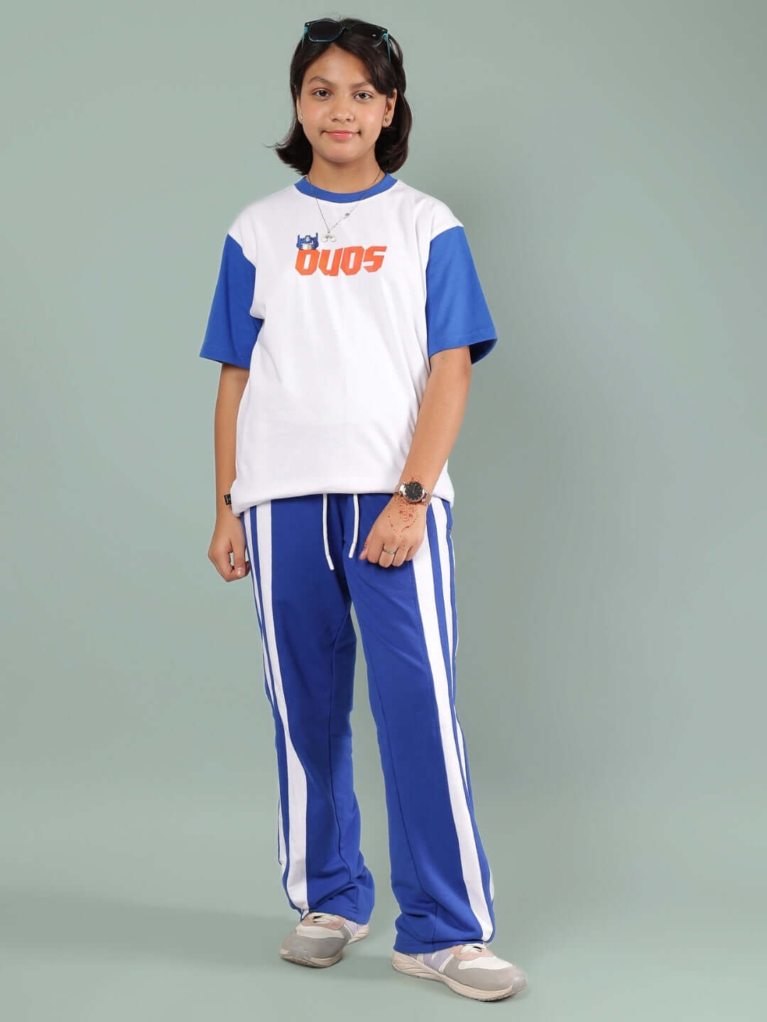 Child wearing IRONA CO-ORD FOR BOYS & GIRLS WHITE-R BLUE with white shirt and blue pants.