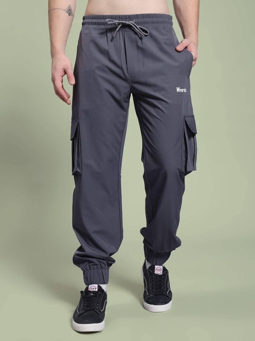Person wearing JACK RELAXED FIT MULTI POCKET CARGO DARK GREY pants, showcasing casual style and utility pockets.
