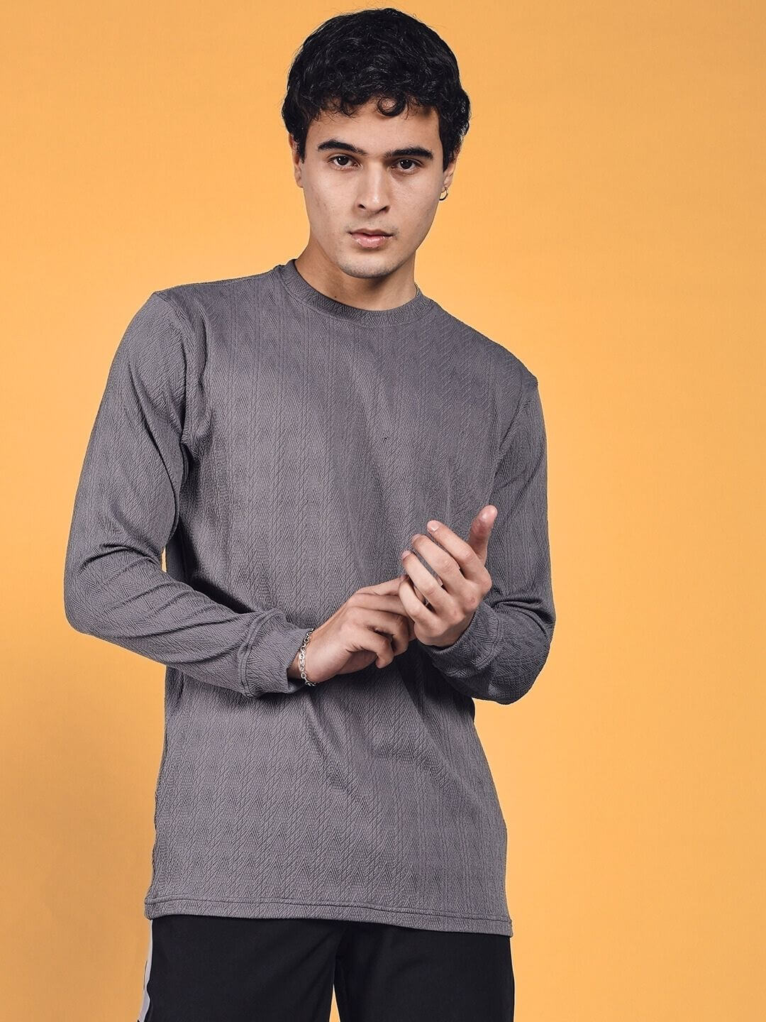 Male model wearing grey Jacob sweatshirt made of premium heavy gauge jacquard lycra fabric, long sleeves, and crew neck.