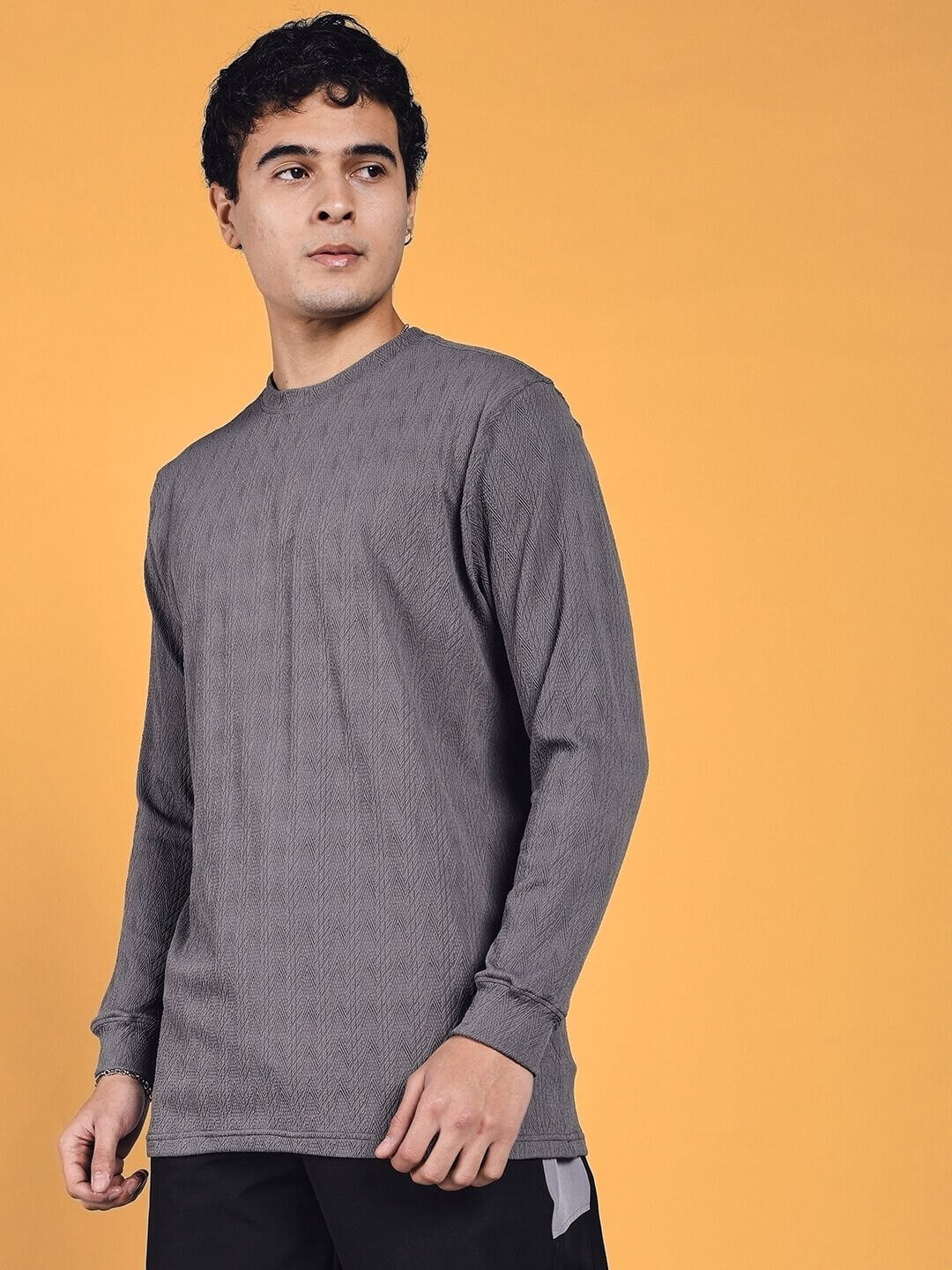 "Man wearing JACOB Sweatshirt in grey, made from heavy gauge jacquard lycra, suitable for cold machine wash. Fashionable and comfortable."