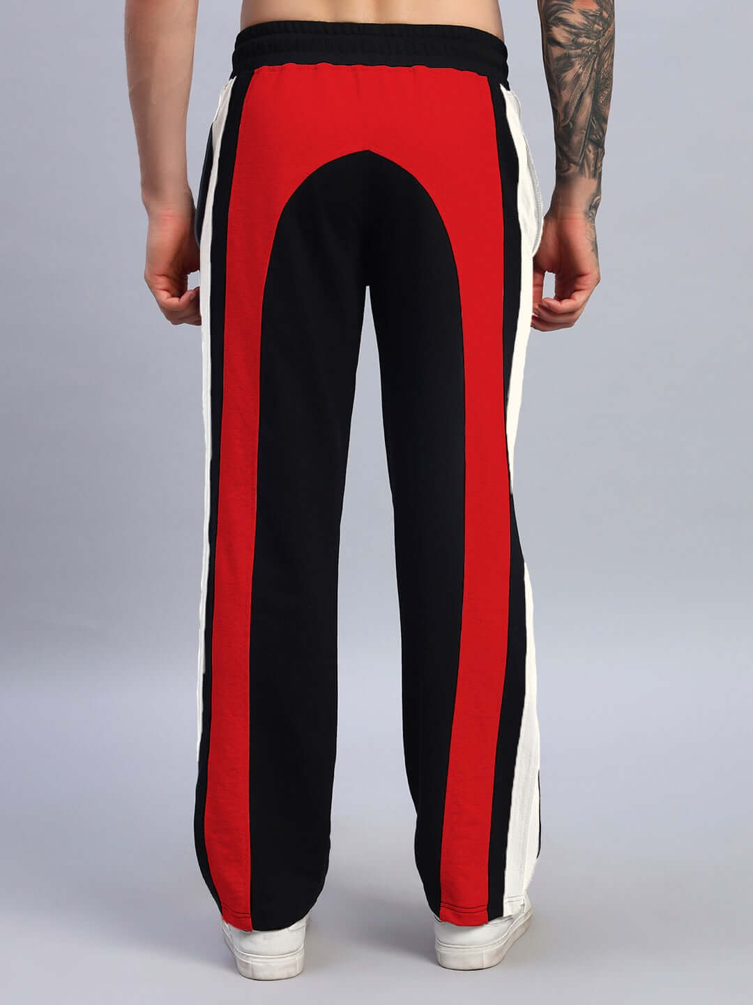 Back view of JAMISON COLOR BLOCK RELAXED-FIT JOGGERS BLACK RED showcasing vibrant contrast panels and relaxed silhouette.