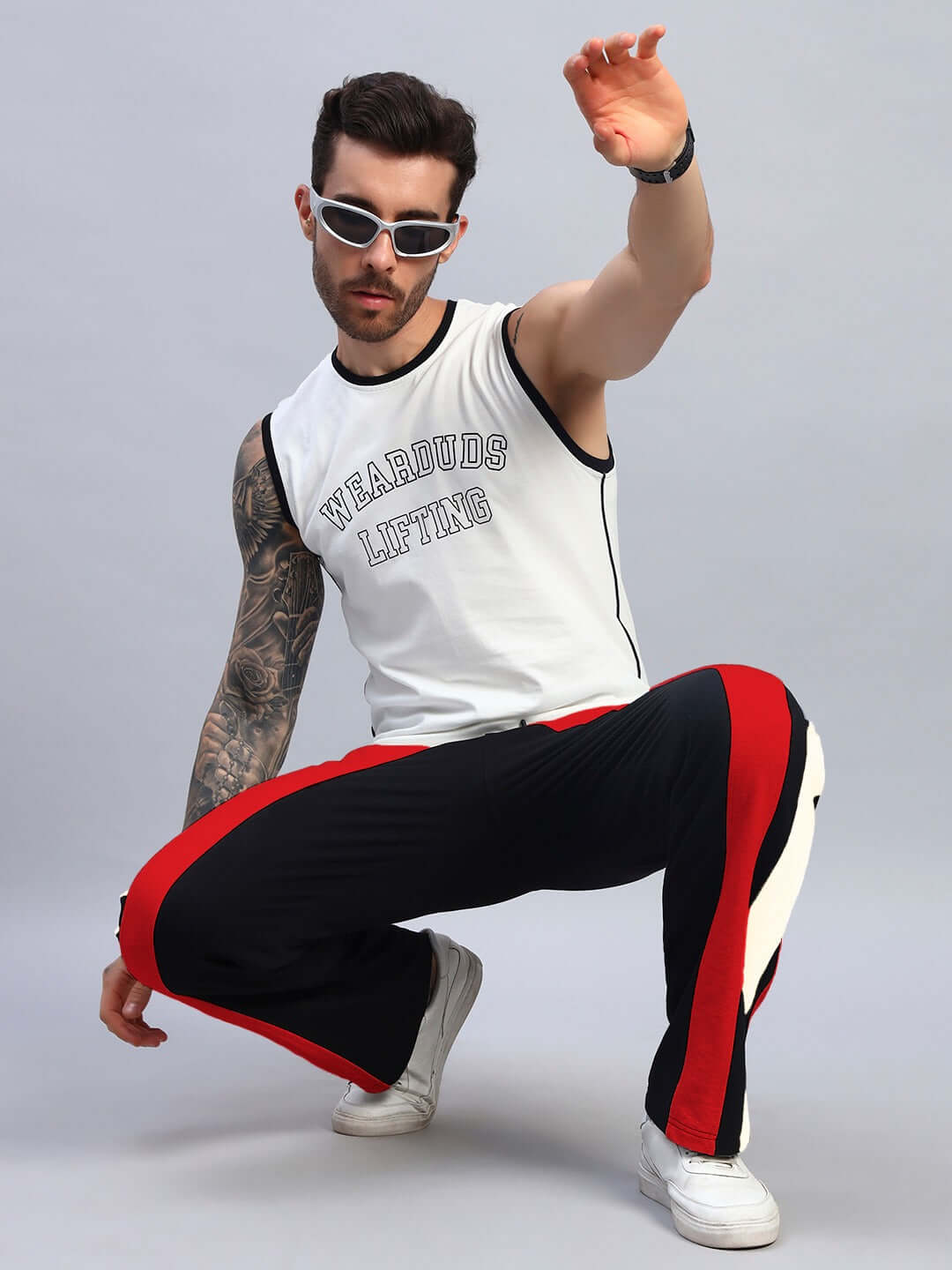 Model wearing JAMISON COLOR BLOCK RELAXED-FIT JOGGERS BLACK RED with bold design and vibrant panels, emphasizing trend-setting streetwear style.