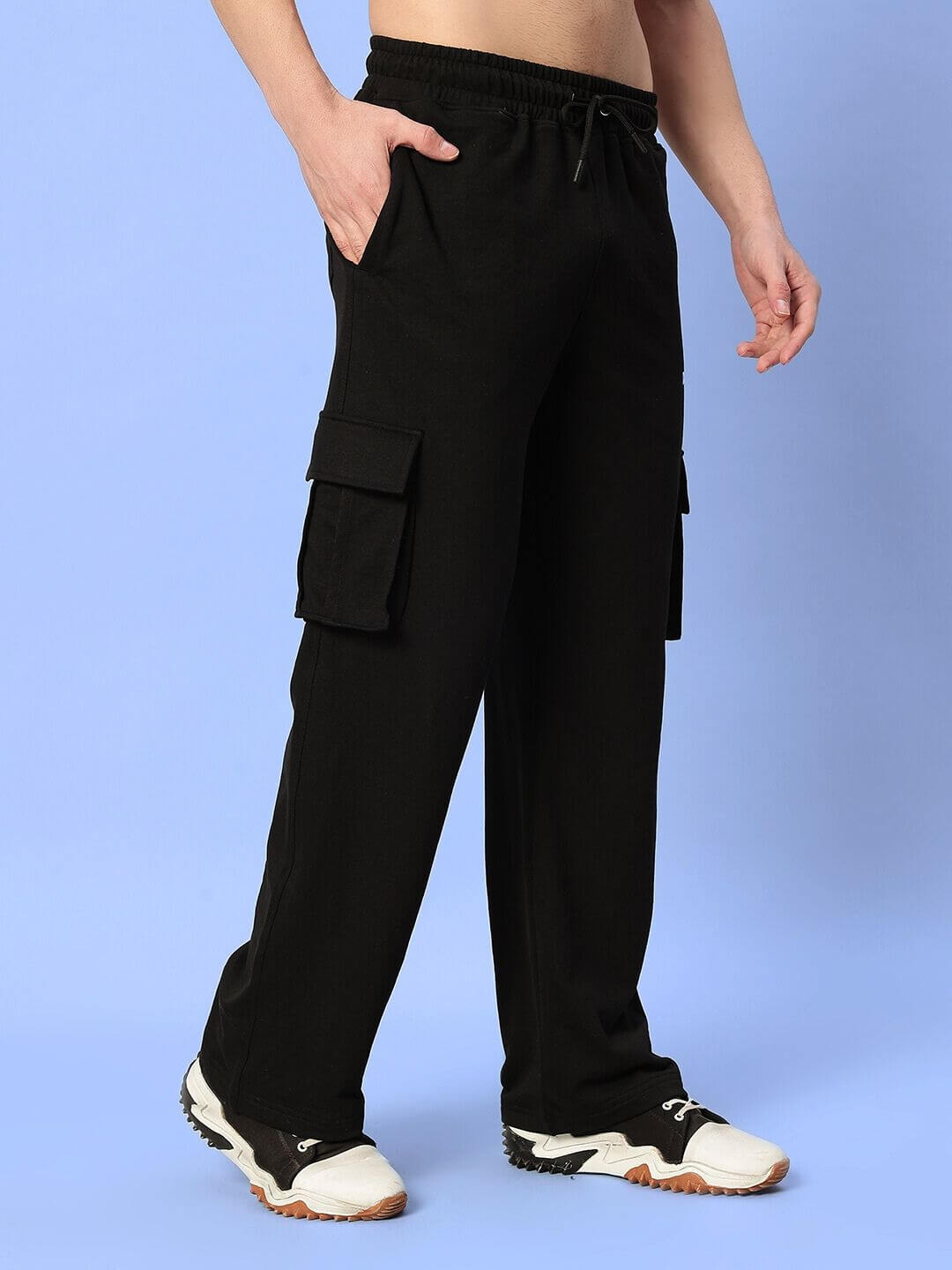 Man wearing black relaxed fit joggers with multiple pockets and sneakers, showcasing JESS 5 Pocket Joggers made by DUDS.