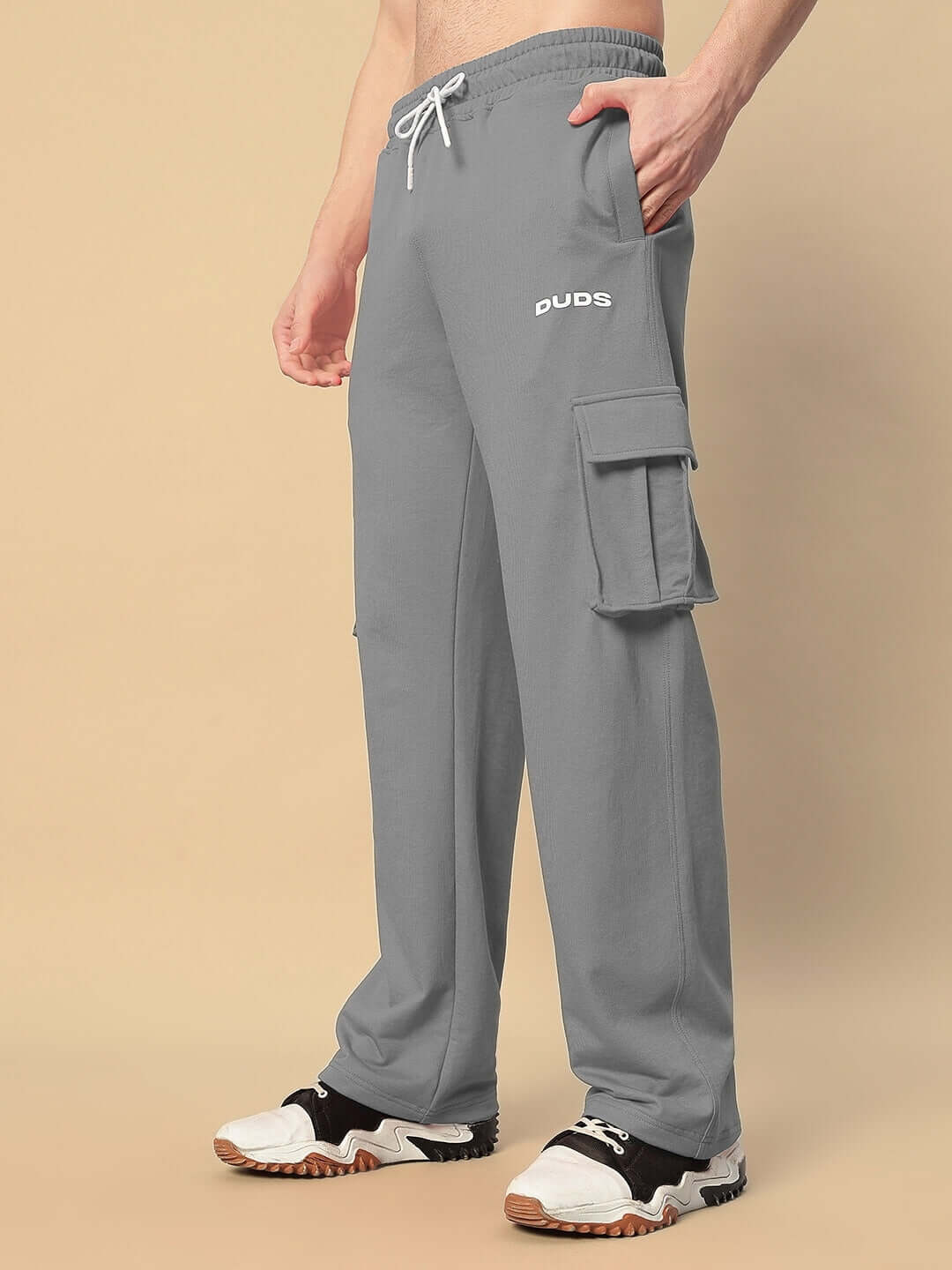 Model wearing JESS 5 Pocket Relaxed Fit Joggers in grey by DUDS, featuring cargo pockets, ideal for a casual look.