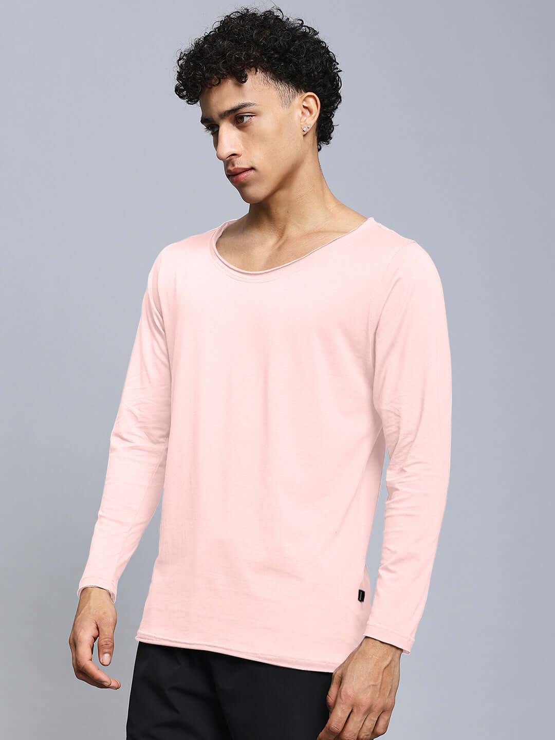 Man wearing Joel Slim Fit Sweatshirt in baby pink, made of 100% cotton, ideal for comfort and style. Premium fabric from India.