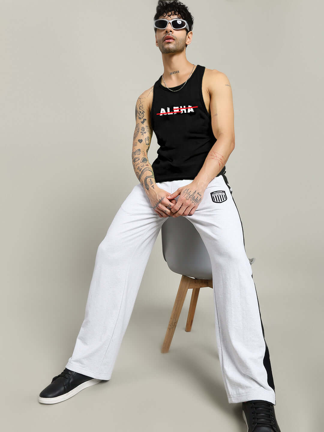 JOJO ALPHA PRINTED GYM T-SHIRT BLACK on a seated model, showcasing the bold "Alpha" graphic design.