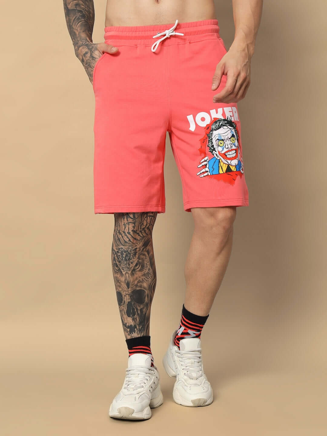 JOKER regular fit shorts in Pantone Peach with a bold graphic, showcasing unique style, available for custom size orders from DUDS.