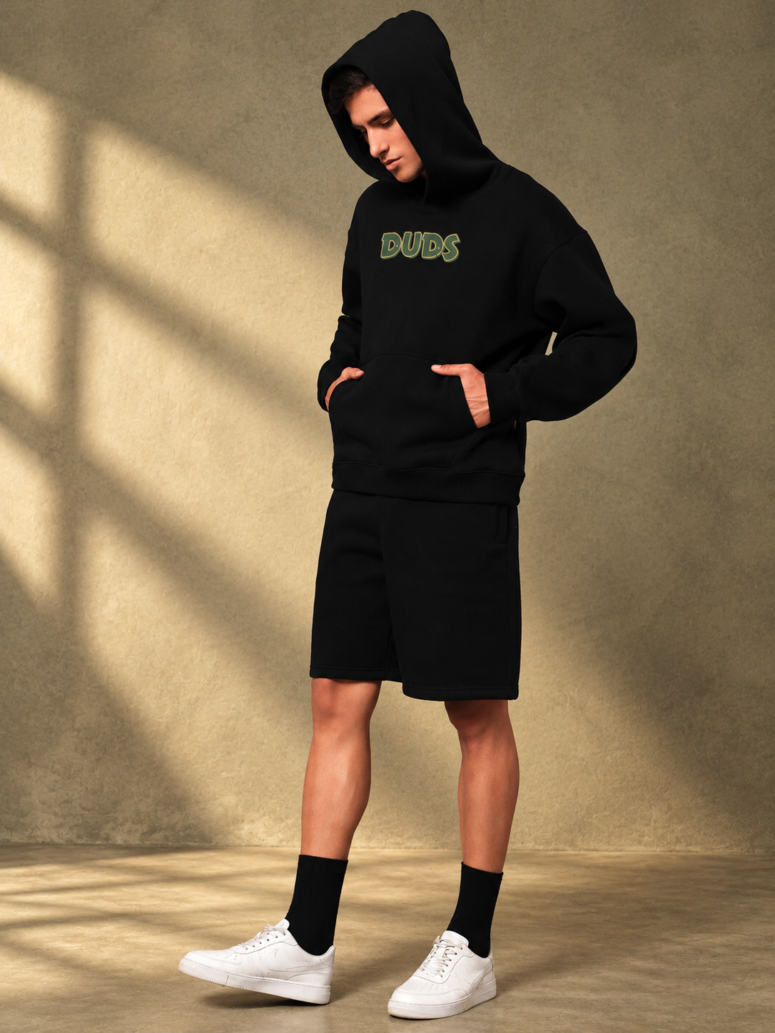 Man wearing JUDY NICK ZOOTOPIA FLEECE CO-ORD BLACK unisex hoodie and shorts set with cartoon print design